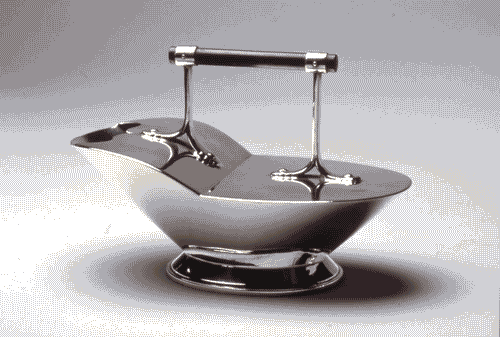 Image for XX Triennale - La memoria e il futuro - Christopher Dresser. Un designer alla corte della regina Vittoria - Scaldacucchiaio in metallo placcato d'argento ed ebano